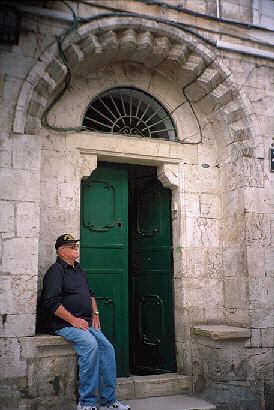 Howard rests outside an ancient church entrance in Jerusalem, 2001